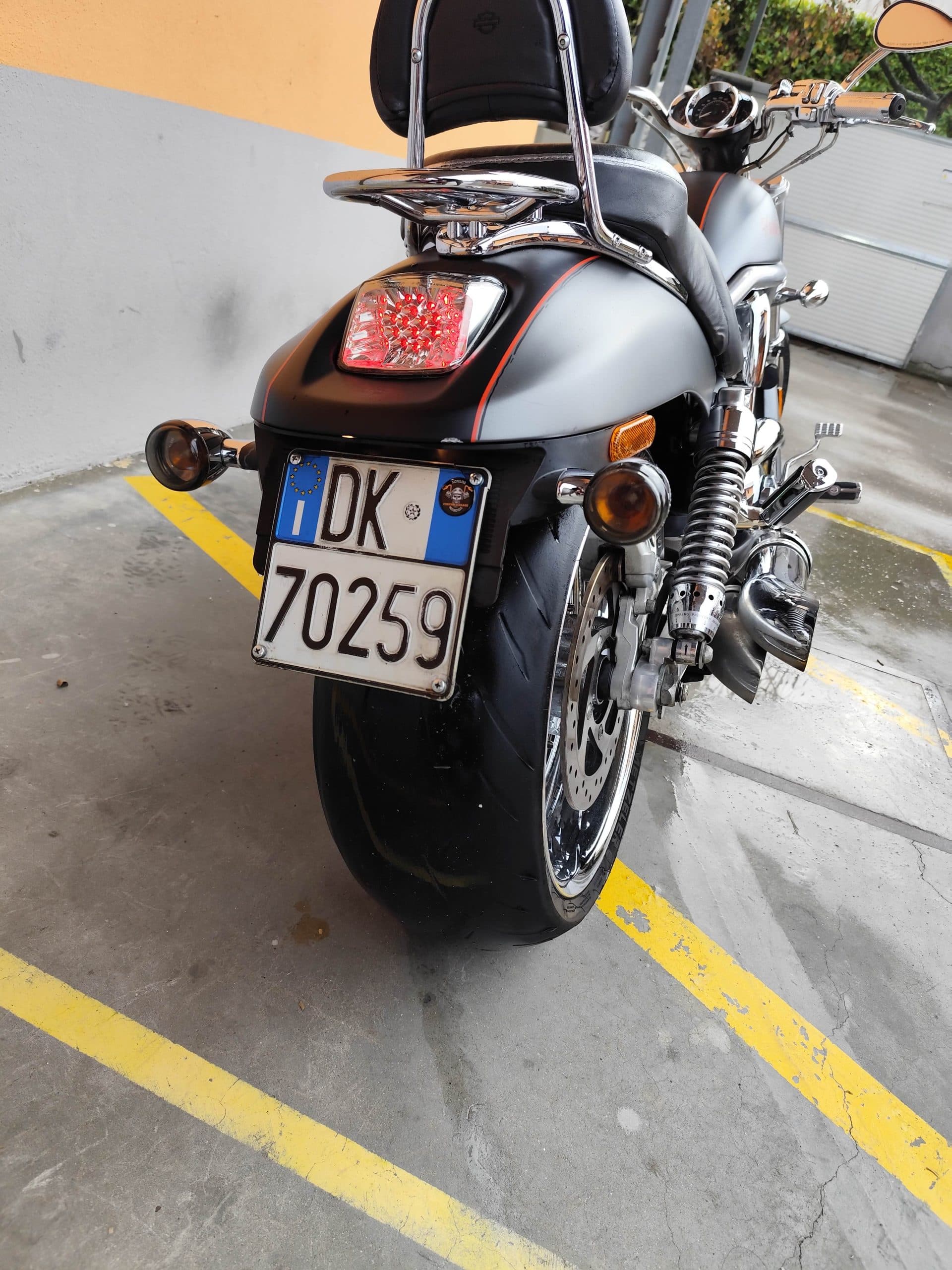 1766134082035.jpg Harley-Davidson V-Rod grigio opaco, vista posteriore. Dettagli cromati, fanale LED, targa italiana DK 70259 e pneumatico posteriore largo. Pronta per un test ride.